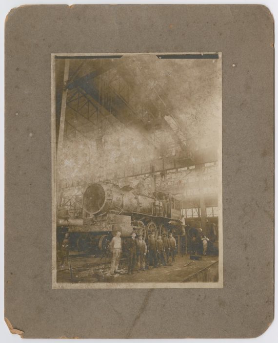 Men Beside an Unfinished Train Engine