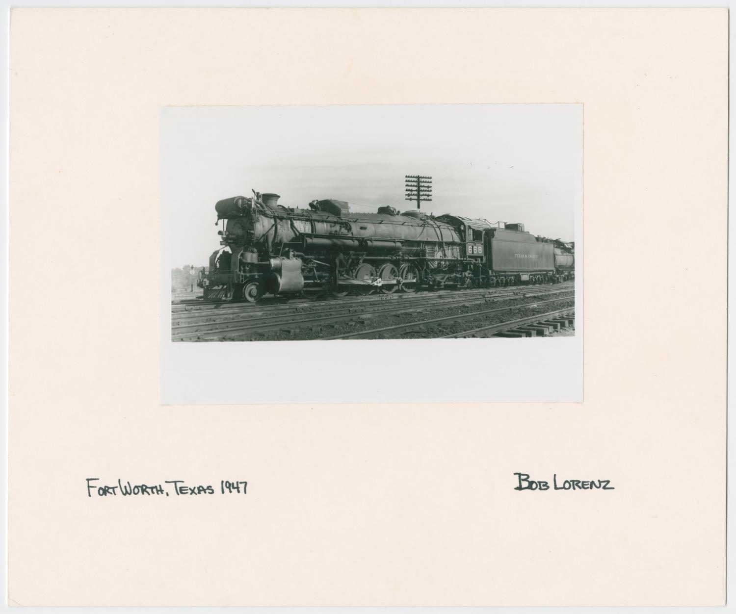 Train Engine #668 and Cars on Tracks