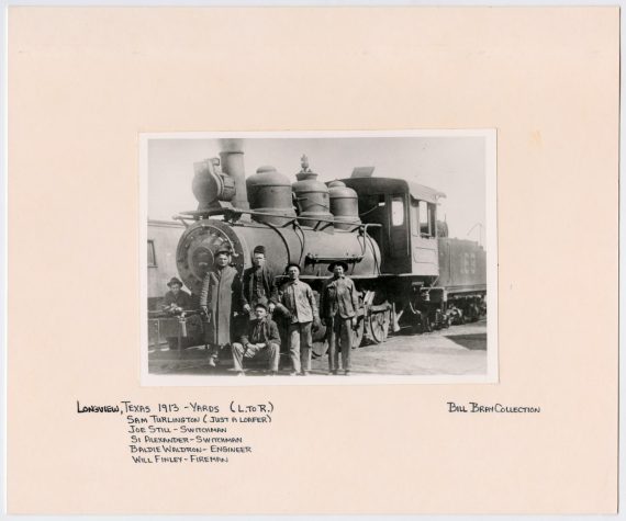 Six Men Posing in Front of a T&P Train