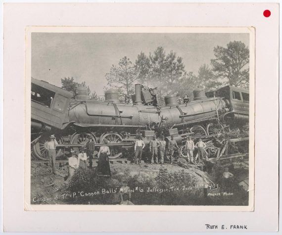 Group Photo Posing in Front of a Train Wreck